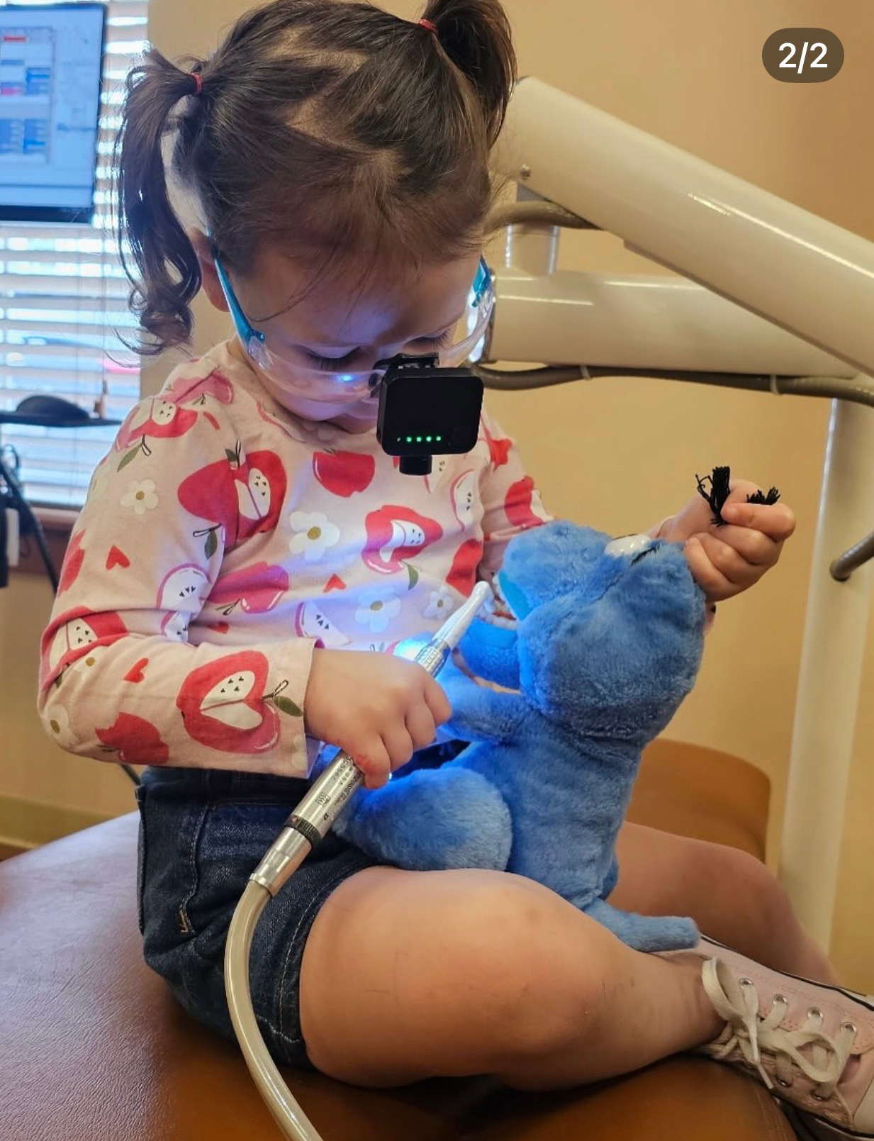 Young patient at McMurphy Pediatric Dentistry pretends to provide dental care to a stuffed animal.